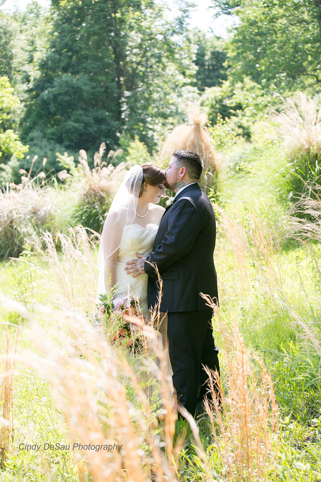 My favorite photo; the bride and groom in the tall grasses.