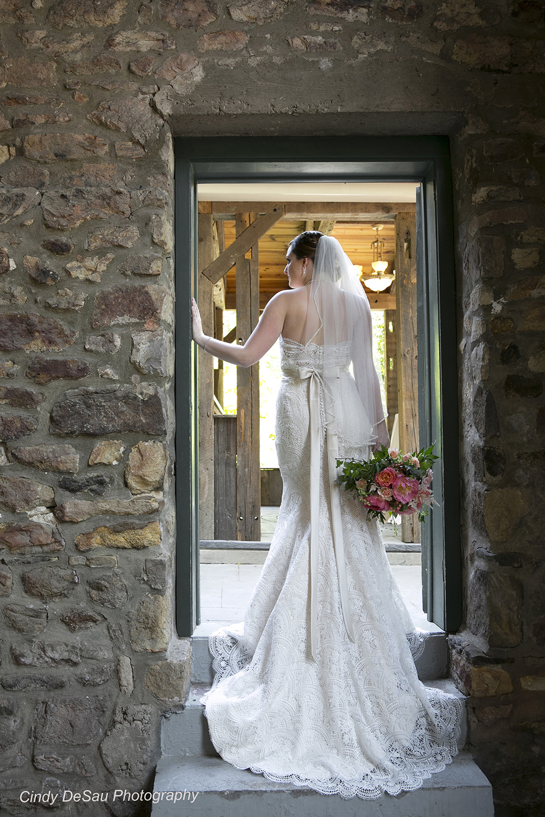 bride in barn doorway