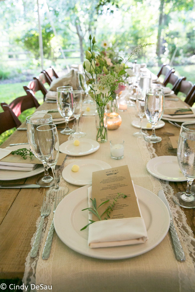 farm tables set under the wedding tent