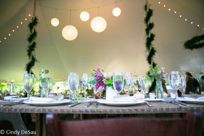 tables set with lanterns and lights above