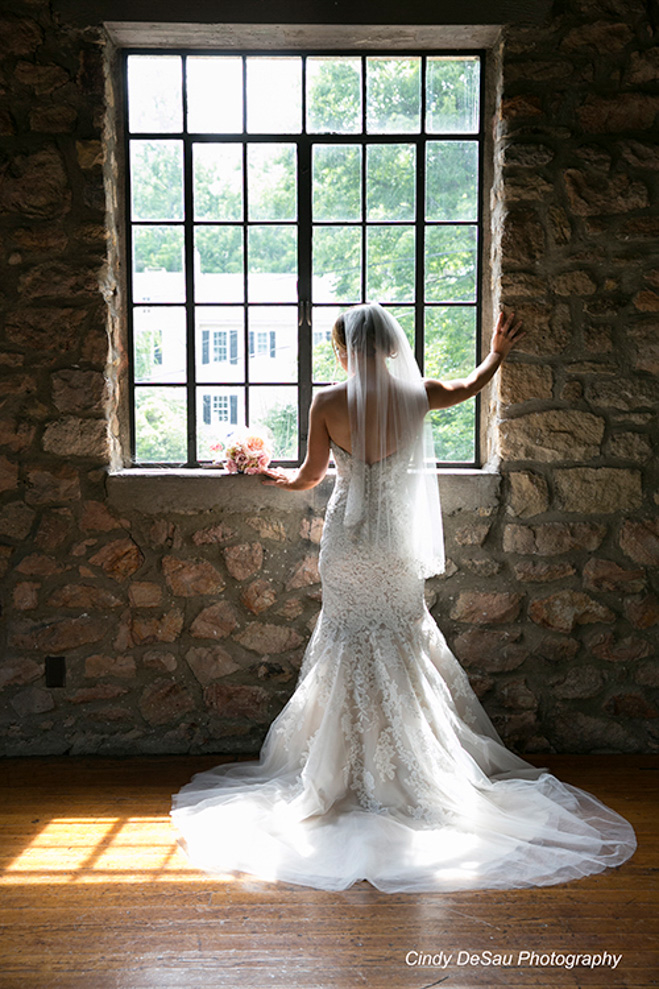 Full length of bride by the window